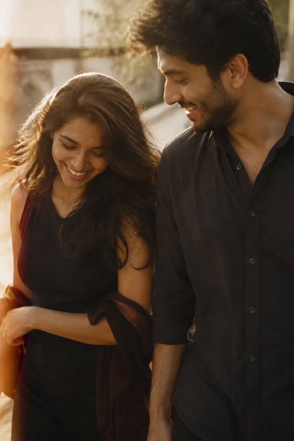 A couple sharing a quiet laugh in warm light