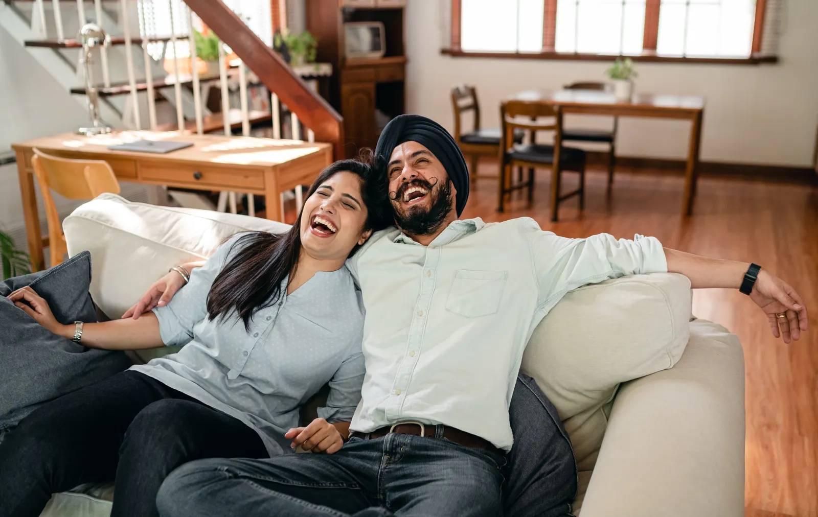 A fictional couple relaxing together in their living room