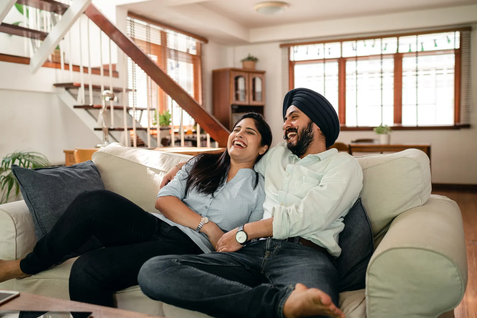 A fictional couple laughing together during a movie night